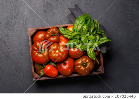 Assorted tomatoes in rustic crate Assorted tomatoes in rustic crate 107026440