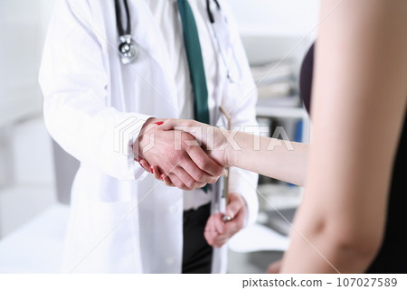 Doctor shake hand as hello with patient in Doctor shake hand as hello with patient in 107027589