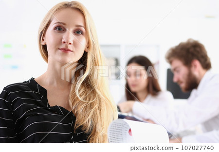 Beautiful smiling cheerful girl at workplace 107027740