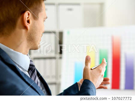 Man in suit point with arm in stats graph 107027772
