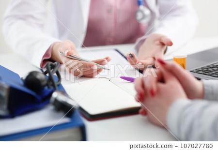 Female doctor hand hold silver pen Female doctor hand hold silver pen 107027780