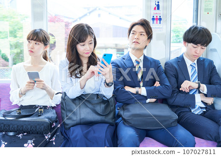 A man and a woman riding a crowded train. Photography provided by Keio Electric Railway Co., Ltd. A man and a woman riding a crowded train. Photography provided by Keio Electric Railway Co., Ltd. 107027811
