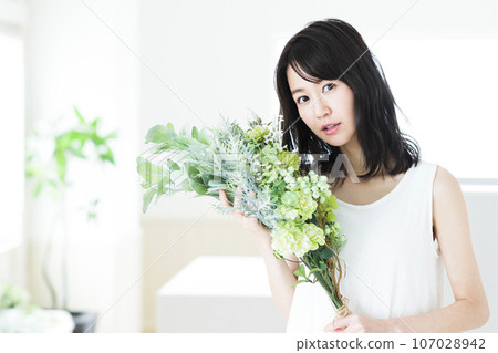 Young woman with a bouquet Young woman with a bouquet 107028942