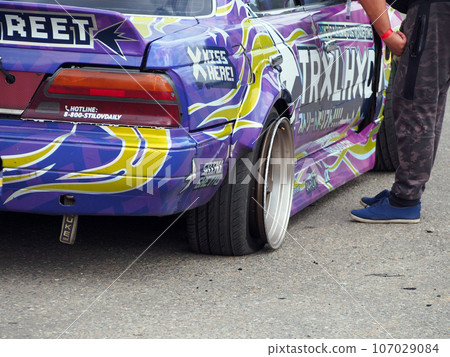 Myachkovo village, Moscow region, Russia-August 15, 2020 Car festival "DriftExpo", a fragment of a car that stopped the race due to a wheel malfunction, close-up. Myachkovo village, Moscow region, Russia-August 15, 2020 Car festival "DriftExpo", a fragment of a car that stopped the race due to a wheel malfunction, close-up. 107029084