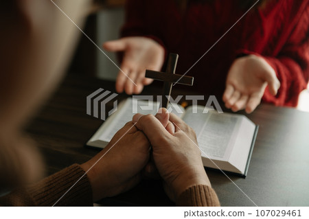 Woman's hand with cross .Concept of hope, faith, christianity, religion, church and pray to God. on the table. 107029461