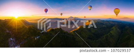 Aerial view panorama of Mount Bromo volcano (Gunung Bromo)in Bromo Tengger Semeru National Park, East Java, Indonesia. Mount Bromo volcano and air balloon on sunrise. fake air balloon. 107029537
