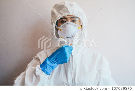 Healthcare worker wearing PPE suit for working in hospital during Covid-19 pandemic. PPE is equipment that will protect the user against health or safety risks at work. Healthcare worker wearing PPE suit for working in hospital during Covid-19 pandemic. PPE is equipment that will protect the user against health or safety risks at work. 107029570