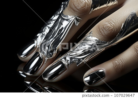Silver color nails. Luxury nails with drawing fantasy design. Closeup Woman hand with beautiful nail design. Female hand with stylish, creative and modern manicure. Women fingers with gloss manicure. 107029647