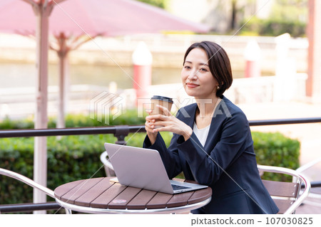 A woman working at an open cafe 107030825