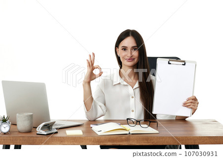 businesswoman in formal wear showing empty clipboard businesswoman in formal wear showing empty clipboard 107030931