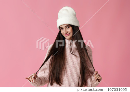 young woman in white hat, pink sweater looking at the camera young woman in white hat, pink sweater looking at the camera 107031095