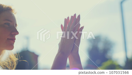 Two women sharing love and support holding hands at sanset background. Lifestyle and relationships. LGBT concept. Two women sharing love and support holding hands at sanset background. Lifestyle and relationships. LGBT concept. 107031566
