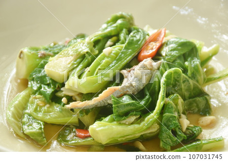 fried Brussels sprout with salty fish in oyster sauce on plate fried Brussels sprout with salty fish in oyster sauce on plate 107031745