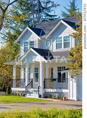 Detached residential house on bright sunny autumn day 107032910