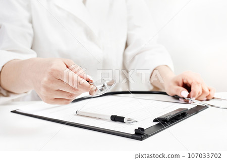 Doctor holding a phonendoscope or stethoscope in his hand Doctor holding a phonendoscope or stethoscope in his hand 107033702
