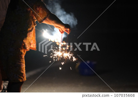 People enjoying hand-held fireworks 107035608