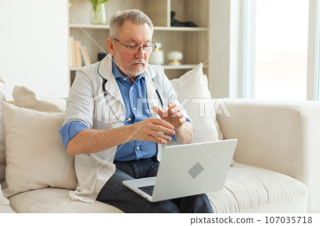Senior man doctor with laptop talk on video call have consultation with patient. Professional senior mature healthcare expert examining patient online. Medicine healthcare medical checkup 107035718