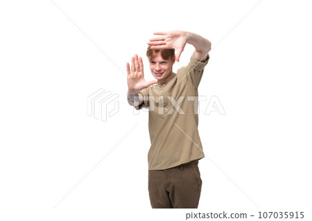 portrait of a handsome young caucasian man with red hair and a tattoo on his arm dressed in a khaki portrait of a handsome young caucasian man with red hair and a tattoo on his arm dressed in a khaki 107035915