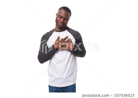 young kind handsome African guy with a short haircut dressed in a summer jacket with a long sleeve young kind handsome African guy with a short haircut dressed in a summer jacket with a long sleeve 107036025