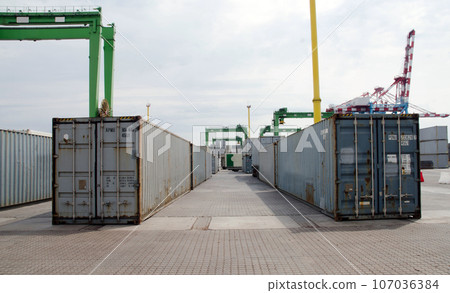 Container terminal. Sea port container terminal during work at night in fog 107036384