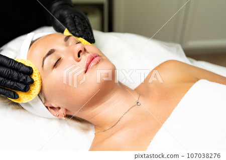 Beautiful blonde woman at an appointment with a cosmetologist. Beautiful blonde woman at an appointment with a cosmetologist. 107038276