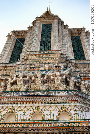A temple in Thailand with intricate details and a tall spire. The temple is decorated with intricate details and patterns. A temple in Thailand with intricate details and a tall spire. The temple is decorated with intricate details and patterns. 107039203