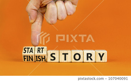 Start or finish story symbol. Concept words Start story and Finish story on wooden cubes. Beautiful orange table orange background. Businessman hand. Business start or finish story concept. Copy space Start or finish story symbol. Concept words Start story and Finish story on wooden cubes. Beautiful orange table orange background. Businessman hand. Business start or finish story concept. Copy space 107040091