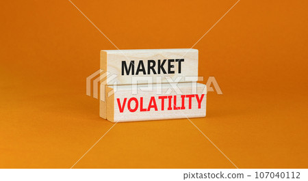 Market volatility symbol. Concept words Market volatility on beautiful wooden blocks. Beautiful orange table yellow background. Business market volatility concept. Copy space.orange Market volatility symbol. Concept words Market volatility on beautiful wooden blocks. Beautiful orange table yellow background. Business market volatility concept. Copy space.orange 107040112