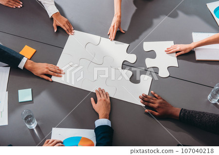 Businessmen working together to build a puzzle as teamwork, partnership and integration concept Businessmen working together to build a puzzle as teamwork, partnership and integration concept 107040218