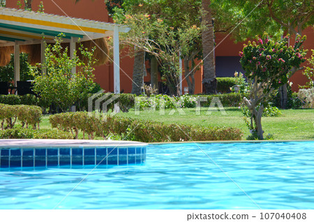 Blue clear water with small ripple waves in swimming pool at tropical resort. Summer vacations concept. 107040408