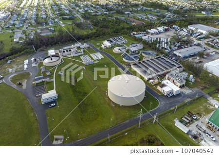Aerial view of water treatment factory at city wastewater cleaning facility. Purification process of removing undesirable chemicals, suspended solids and gases from contaminated liquid Aerial view of water treatment factory at city wastewater cleaning facility. Purification process of removing undesirable chemicals, suspended solids and gases from contaminated liquid 107040542