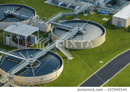 Aerial view of water treatment factory at city wastewater cleaning facility. Purification process of removing undesirable chemicals, suspended solids and gases from contaminated liquid 107040544