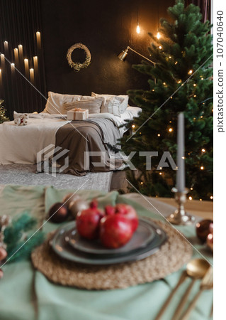 Serving a festive Christmas table in Scandinavian style. Decor on the table before the holiday. Serving a festive Christmas table in Scandinavian style. Decor on the table before the holiday. 107040640