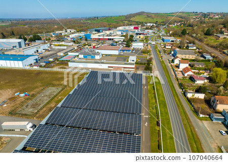 Aerial view of solar panels installed over parking lot with parked cars for effective generation of clean energy 107040664