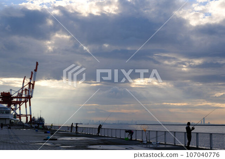 Angel's Staircase where the sun's rays reach the sea from the early morning clouds. Photographed at Rokko Island Marine Park, Kobe City, Hyogo Prefecture. Angel's Staircase where the sun's rays reach the sea from the early morning clouds. Photographed at Rokko Island Marine Park, Kobe City, Hyogo Prefecture. 107040776