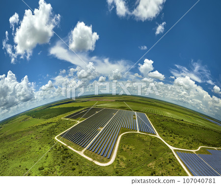 Aerial view of large sustainable electrical power plant with rows of solar photovoltaic panels for producing clean electric energy. Concept of renewable electricity with zero emission 107040781
