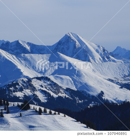 Snow covered mountains seen from the Horneggli ski area, Switzerland. 107040891