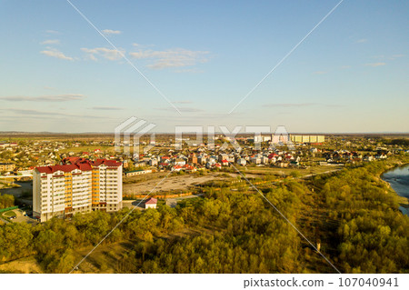 Aerial view of high residential apartment building in green rural area in Ivano-Frankivsk city, Ukraine Aerial view of high residential apartment building in green rural area in Ivano-Frankivsk city, Ukraine 107040941