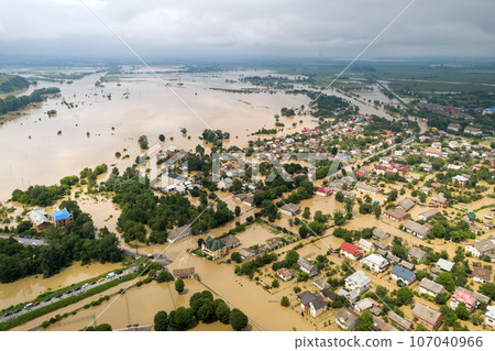 Aerial view of flooded houses with dirty water of Dnister river in Halych town, western Ukraine. Aerial view of flooded houses with dirty water of Dnister river in Halych town, western Ukraine. 107040966