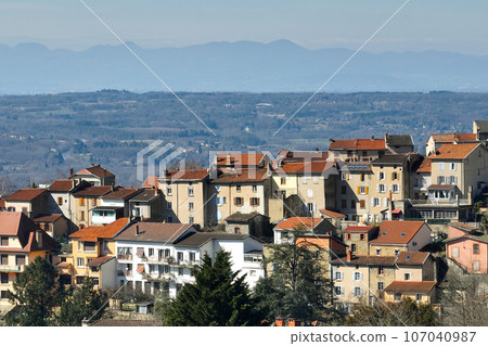 Aerial view of dense historic center of Thiers town in Puy-de-Dome department, Auvergne-Rhone-Alpes region in France. Rooftops of old buildings and narrow streets 107040987