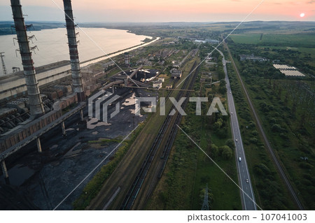 Aerial view of coal power plant high pipes with black smokestack polluting atmosphere. Electricity production with fossil fuel concept 107041003