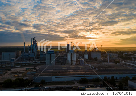 Aerial view of cement factory tower with high concrete plant structure at industrial production area. Manufacturing and global industry concept. 107041015