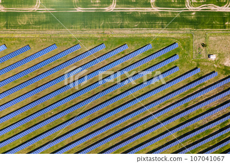 Aerial view of big sustainable electric power plant with many rows of solar photovoltaic panels for producing clean ecological electrical energy. Renewable electricity with zero emission concept 107041067