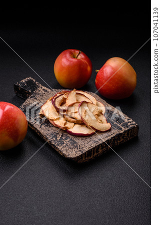 Delicious ripe red apple, sliced and dried in a special dryer Delicious ripe red apple, sliced and dried in a special dryer 107041139