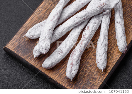 Delicious Spanish smoked sausage fuet with salt and spices 107041163