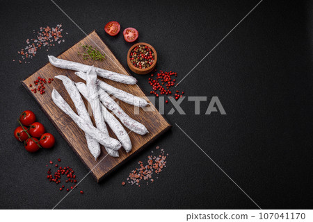 Delicious Spanish smoked sausage fuet with salt and spices 107041170