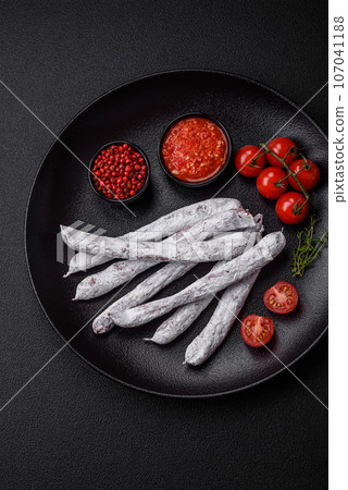 Delicious Spanish smoked sausage fuet with salt and spices Delicious Spanish smoked sausage fuet with salt and spices 107041188