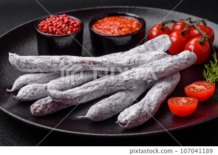 Delicious Spanish smoked sausage fuet with salt and spices 107041189