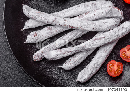 Delicious Spanish smoked sausage fuet with salt and spices 107041190