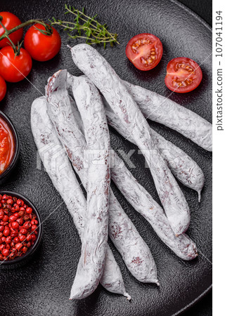 Delicious Spanish smoked sausage fuet with salt and spices 107041194